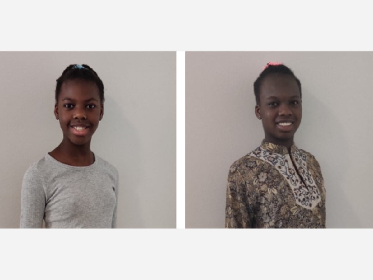 two sisters smiling at a portrait